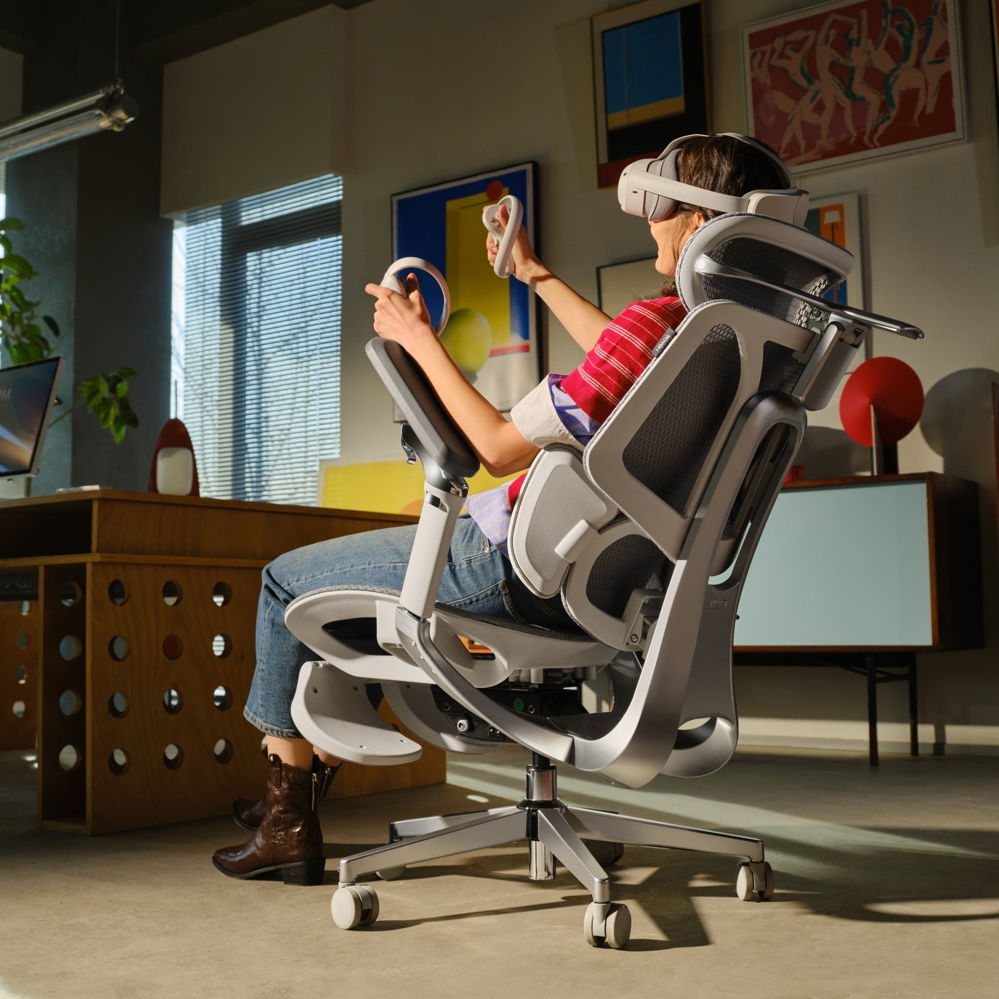 Person using a high-tech gaming chair in a modern office setting~scene